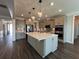 A modern gray kitchen features a large center island with quartz countertops and stainless steel appliances at 5458 Summer Pine Pl, Buford, GA 30518