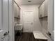 Convenient laundry room features gray cabinets and a utility sink at 5458 Summer Pine Pl, Buford, GA 30518