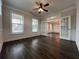 Bright living room with ceiling fan, hardwood floors, and ample natural light at 5458 Summer Pine Pl, Buford, GA 30518