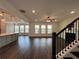 Open-concept living area with hardwood floors, a fireplace, and an adjacent kitchen and dining area at 5458 Summer Pine Pl, Buford, GA 30518
