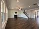 Open living area with hardwood floors, fireplace, large windows, and open access to entryway at 5458 Summer Pine Pl, Buford, GA 30518