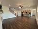 Spacious living room with a cozy fireplace, staircase, and open access to the kitchen at 5458 Summer Pine Pl, Buford, GA 30518