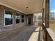 Covered porch with brick detailing, wood railing, offering a serene outdoor space at 5458 Summer Pine Pl, Buford, GA 30518