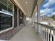 Spacious porch with a view of the neighborhood, showcasing the home's brick facade at 5458 Summer Pine Pl, Buford, GA 30518