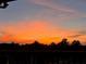 A vivid orange sunset view from the porch, offering a serene and picturesque backdrop at 5458 Summer Pine Pl, Buford, GA 30518