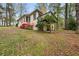 Backyard exterior of home featuring a small deck and landscaping with a large lawn at , Stone Mountain, GA 30088