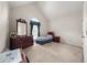 Well-lit bedroom with vaulted ceiling, dresser, bed, and window with dark curtains at , Stone Mountain, GA 30088