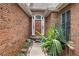 Inviting brick entryway with a charming front door, decorative plants, and natural light at , Stone Mountain, GA 30088