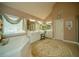Spa-like primary bathroom with a deep soaking tub, dual vanities, and ample counter space at 2557 Staunton Dr, Duluth, GA 30097