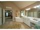 Large primary bathroom features a soaking tub, dual vanities, and a separate shower at 2557 Staunton Dr, Duluth, GA 30097