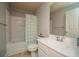 Neutral bathroom with a shower-tub combo and a single sink vanity with framed mirror at 2557 Staunton Dr, Duluth, GA 30097