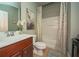 Neat bathroom featuring a vanity, toilet and shower with decorative curtain at 2557 Staunton Dr, Duluth, GA 30097