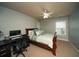 Cozy bedroom with a work space featuring a desk, chair, and a window that provides natural light at 2557 Staunton Dr, Duluth, GA 30097