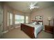 Bright bedroom featuring a ceiling fan, and three large windows that provide natural light at 2557 Staunton Dr, Duluth, GA 30097