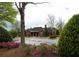 Community clubhouse exterior surrounded by well-maintained landscaping and ample parking at 2557 Staunton Dr, Duluth, GA 30097