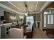 Formal dining room with tray ceiling, modern lighting, and ample seating at 2557 Staunton Dr, Duluth, GA 30097