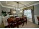 Elegant dining room features tray ceiling, wainscoting and modern lighting at 2557 Staunton Dr, Duluth, GA 30097