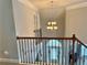 View from upstairs landing showcasing the chandelier and an arched entryway at 2557 Staunton Dr, Duluth, GA 30097