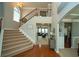 Bright, two-story foyer with hardwood floors, staircase, and decorative touches at 2557 Staunton Dr, Duluth, GA 30097