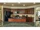 Kitchen featuring granite countertops, stainless steel appliances, and dark cabinetry with a view to the breakfast area at 2557 Staunton Dr, Duluth, GA 30097