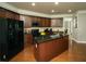 Well-lit kitchen features stainless steel appliances, dark wood cabinets, and granite countertops at 2557 Staunton Dr, Duluth, GA 30097