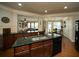Gourmet kitchen with granite countertops, custom cabinets and view to the breakfast and living rooms at 2557 Staunton Dr, Duluth, GA 30097