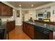 Gourmet kitchen with granite countertops, custom cabinets and view to the living room at 2557 Staunton Dr, Duluth, GA 30097