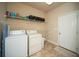 Functional laundry room with washer, dryer, overhead shelving, and storage at 2557 Staunton Dr, Duluth, GA 30097