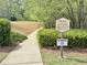 Community trail access sign along a paved path surrounded by lush greenery at 2557 Staunton Dr, Duluth, GA 30097