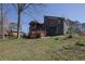 Backyard view of the house featuring a wooden deck and well-maintained lawn at 525 Penny Ln, Woodstock, GA 30188