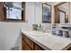 Bathroom with vanity, white countertop, and a window offering natural light at 525 Penny Ln, Woodstock, GA 30188