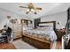 Bedroom with a large bed, wood floors, storage, and a ceiling fan at 525 Penny Ln, Woodstock, GA 30188