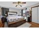 Bedroom featuring a large bed, ceiling fan, hardwood floors, and closet at 525 Penny Ln, Woodstock, GA 30188