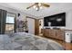 Bedroom with hardwood floors, ceiling fan, mounted television, and closet at 525 Penny Ln, Woodstock, GA 30188