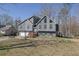 Beautiful home with a two-car garage, inviting front yard, and mature trees at 525 Penny Ln, Woodstock, GA 30188