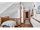 Light and airy upstairs hallway with hardwood floors and stylish decor provides a warm and inviting welcome at 525 Penny Ln, Woodstock, GA 30188