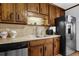 A well-equipped kitchen boasts wooden cabinets, stainless steel appliances, and a practical countertop setup at 525 Penny Ln, Woodstock, GA 30188