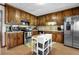 Bright kitchen featuring abundant wood cabinets, stainless steel appliances, and a central island for meal prep at 525 Penny Ln, Woodstock, GA 30188