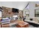 Cozy living room features a stone fireplace and ample natural light from a window at 525 Penny Ln, Woodstock, GA 30188