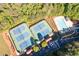 Birds-eye view of community tennis courts, pool, clubhouse, and parking area, and surrounding trees at 5628 Harbormist Dr, Powder Springs, GA 30127