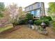 Backyard features a patio area with mature trees and flowering shrubs at 5628 Harbormist Dr, Powder Springs, GA 30127