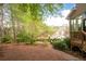 Expansive backyard with wooded views, offering privacy and a serene setting at 5628 Harbormist Dr, Powder Springs, GA 30127