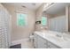 Well-lit bathroom with a neutral palette features a shower, and a large vanity at 5628 Harbormist Dr, Powder Springs, GA 30127