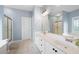 Bright bathroom features a double vanity, large mirror, and separate shower and tub at 5628 Harbormist Dr, Powder Springs, GA 30127