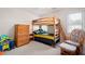 Bedroom features a bunk bed, dresser, and cozy rocking chair, perfect for  at 5628 Harbormist Dr, Powder Springs, GA 30127