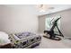 Cozy bedroom with natural light from the window, exercise machine, and a colorful quilt at 5628 Harbormist Dr, Powder Springs, GA 30127