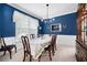 Elegant dining room with blue walls, white trim, and a stylish chandelier at 5628 Harbormist Dr, Powder Springs, GA 30127