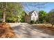 Front exterior view showcasing the driveway, two-story home, and lush landscaping at 5628 Harbormist Dr, Powder Springs, GA 30127