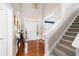 Bright, welcoming foyer with hardwood floors, a staircase, and views to the front door at 5628 Harbormist Dr, Powder Springs, GA 30127