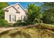 Charming front exterior view of a well-maintained home with manicured landscaping at 5628 Harbormist Dr, Powder Springs, GA 30127